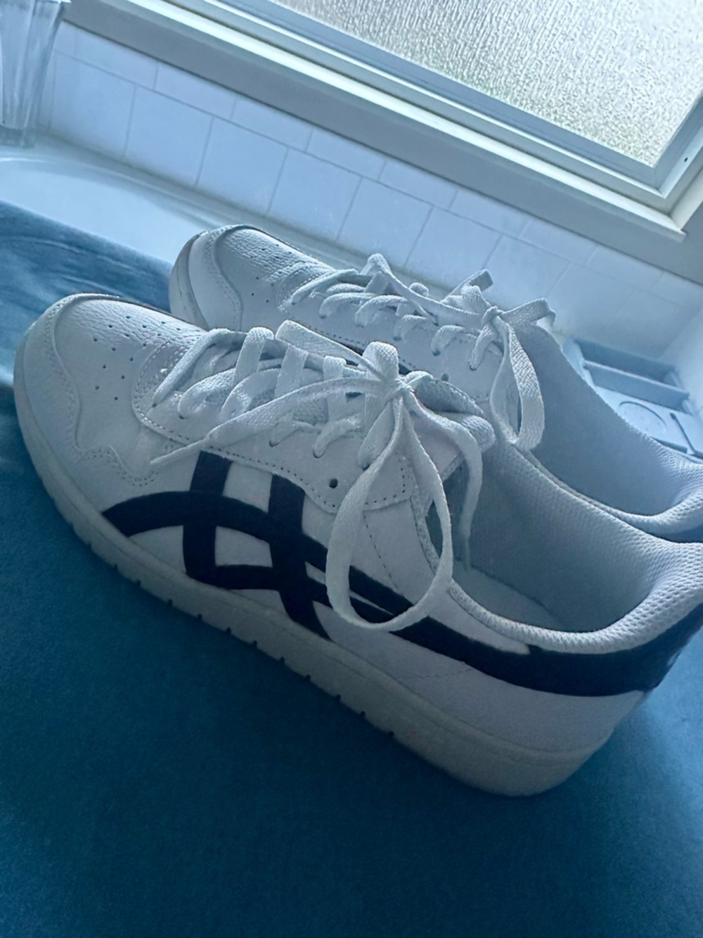 Women’s white ASICS with navy blue size 8